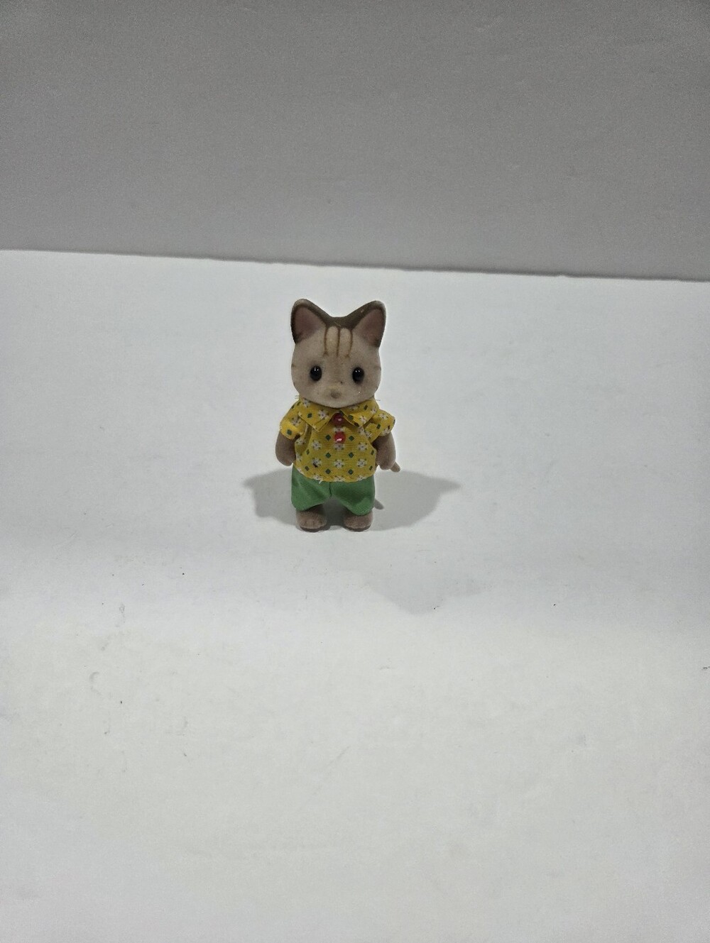 Sylvanian Families Plush-Look Small Pet Figure in Yellow Shirt and Green Shorts